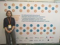 [Translate to Русский:] Dr Anna Kushnir near the brandwall of the Conference