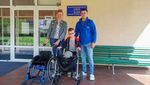 Demian with his new wheelchair and walkers